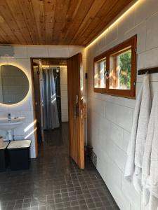 a bathroom with a sink and a toilet and a mirror at Glamping by the sea in Äggrund