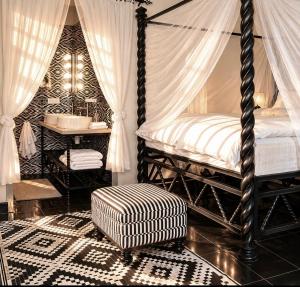 a bedroom with a canopy bed and a sink at RoofTop Boutique Hotel Adults Only in Serekunda +120 photos