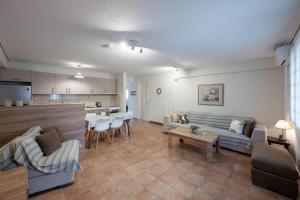 a living room with a couch and a table at Makis Apartments in Tsoukalades