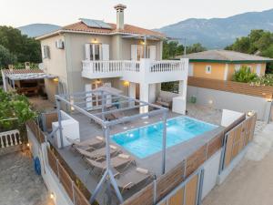 a house with a swimming pool on top of a house at Villa Mary in Kefallonia