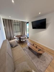 a living room with a couch and a table at Cocon de Montluçon in Montluçon