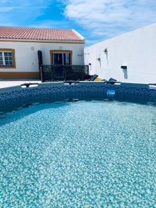 a swimming pool in front of a house at Lugar da Praia - Consolação - Peniche in Peniche