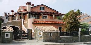 a large house with a gate and a fence at Apartments Villa Marittima in Izola