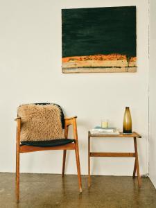 a chair and a table next to a painting at Kjarnholt in Kjarnholt +27 photos