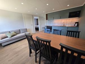 a living room with a table and chairs and a couch at Trellebystrands Camping in Lysekil