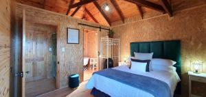 a bedroom with a bed and a wooden ceiling at 7 on Kloof in Mossel Bay