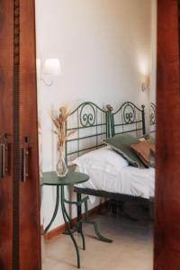 a bedroom with a bed and a table with a vase on it at Villa Incina - Sea House in Polignano a Mare