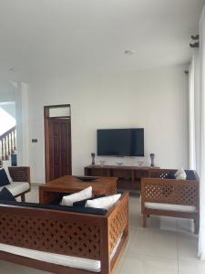 a living room with couches and a flat screen tv at Villa in Vipingo in Vipingo
