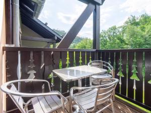 a patio with a table and chairs on a balcony at Les Chalets d Ax N212 - 2P6C in Ax-les-Thermes