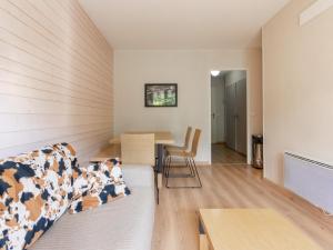 a living room with a couch and a table at Les Chalets d Ax N212 - 2P6C in Ax-les-Thermes