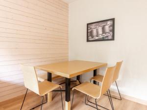 a wooden table and chairs in a room at Les Chalets d Ax N212 - 2P6C in Ax-les-Thermes +5 photos