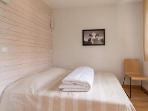 a bedroom with a bed with towels on it at Les Chalets d Ax N212 - 2P6C in Ax-les-Thermes