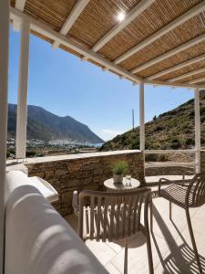 a patio with a table and chairs and a view at Thyme Timeless Stay in Kamares