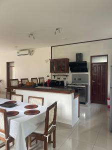 a kitchen with a table and chairs and a stove at Villa in Vipingo in Vipingo