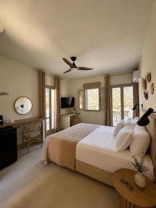 a bedroom with a bed and a ceiling fan at Thyme Timeless Stay in Kamares