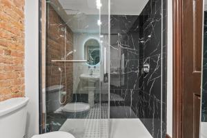 a bathroom with a shower and a toilet and a sink at Le Clos Saint-Louis - Par Aneyro in Quebec City +85 photos