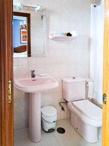 a bathroom with a pink sink and a toilet at Hotel Imperial in Tazones +61 photos
