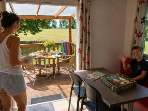 a man and a woman standing in a house at Camping le Rural- 3 étoiles in Tibiran-Jaunac