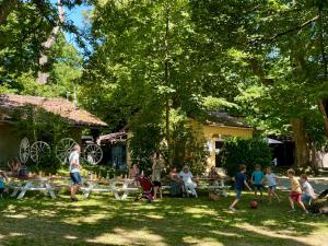 a group of people playing soccer in a yard at Camping le Rural- 3 étoiles in Tibiran-Jaunac
