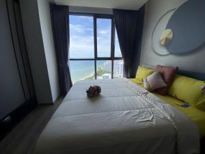 a bedroom with a large bed and a large window at Breath Taking View, Amazing Sea View Room in Pattaya South