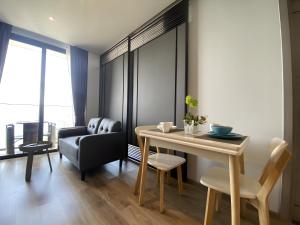 a living room with a table and a couch at Breath Taking View, Amazing Sea View Room in Pattaya South