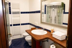 a bathroom with a sink and a toilet and a mirror at Officine Bordighera in Bordighera