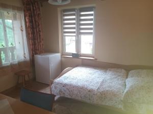 a bedroom with a bed and a window at Noclegi ''U Wandy'' in Polańczyk +1 photo