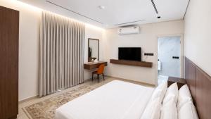a hotel room with a bed and a television at OrbitNet - Anwarat in Medina