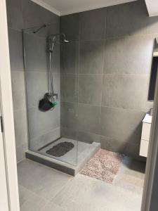 a shower with a glass door in a bathroom at Modern Apartment Constanța in Constanţa