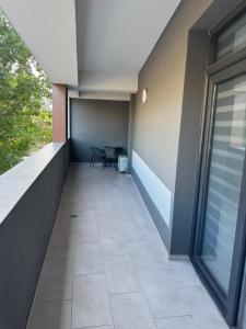 a balcony with a table and chairs in a building at Modern Apartment Constanța in Constanţa