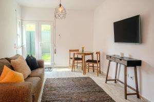 a living room with a couch and a table at 1bd Apartment close to beach in Lourinhã