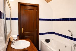 a bathroom with a sink and a toilet and a tub at Officine Bordighera in Bordighera +3 photos