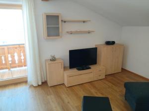 a living room with a flat screen tv on a wooden cabinet at Stapfgut in Rauris