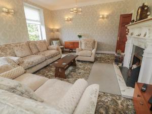 a living room with a couch and a fireplace at Riverdene in Omagh
