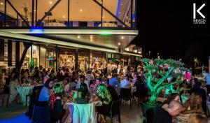 a crowd of people sitting at tables in a building at B&B K Beach Lake Endine in Endine Gaiano