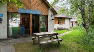 a picnic table in front of a building at Newtonmore Hostel in Newtonmore