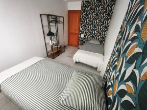 a room with two beds and a mirror at Berges de la Suippe in Warmeriville