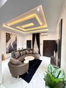a living room with a couch and a table at The Palm Luxe Apartment in Calabar
