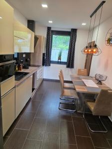 a kitchen and dining room with a table and chairs at Random Villa in Révfülöp