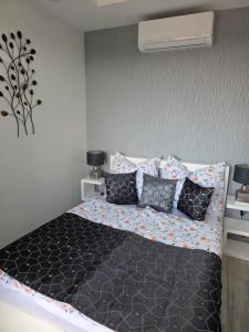 a bedroom with a large bed with pillows at Random Villa in Révfülöp