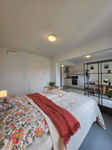 a bedroom with a bed with a blanket on it at Kyyveden Kartano Horsma 14 in Mikkeli