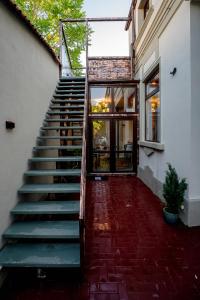 a staircase leading up to a building with glass doors at Luna Boutique in Bucharest