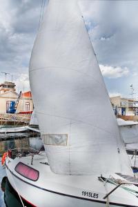 a white sail boat sitting in the water at VRS - Low Cost Beach Boat in Leça da Palmeira