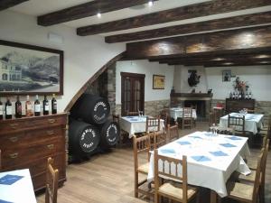 a dining room with two tables and a fireplace at Las Parras in Rute
