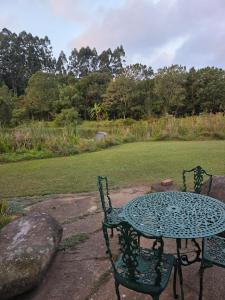 a table and chairs sitting next to a field at Haines Haven in Albinia +2 photos