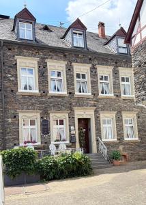 an old brick building with white windows and stairs at Winzerhaus St Joseph in Piesport