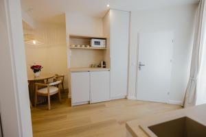 a small room with a kitchen and a table at Camelia's cozy place in Baia Mare +75 photos