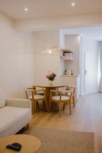 a living room with a table and a couch at Camelia's cozy place in Baia Mare