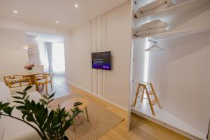 a living room with a tv on the wall at Camelia's cozy place in Baia Mare