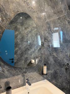 ein Badezimmer mit Waschbecken und Spiegel in der Unterkunft Bay View Hotel in Himarë